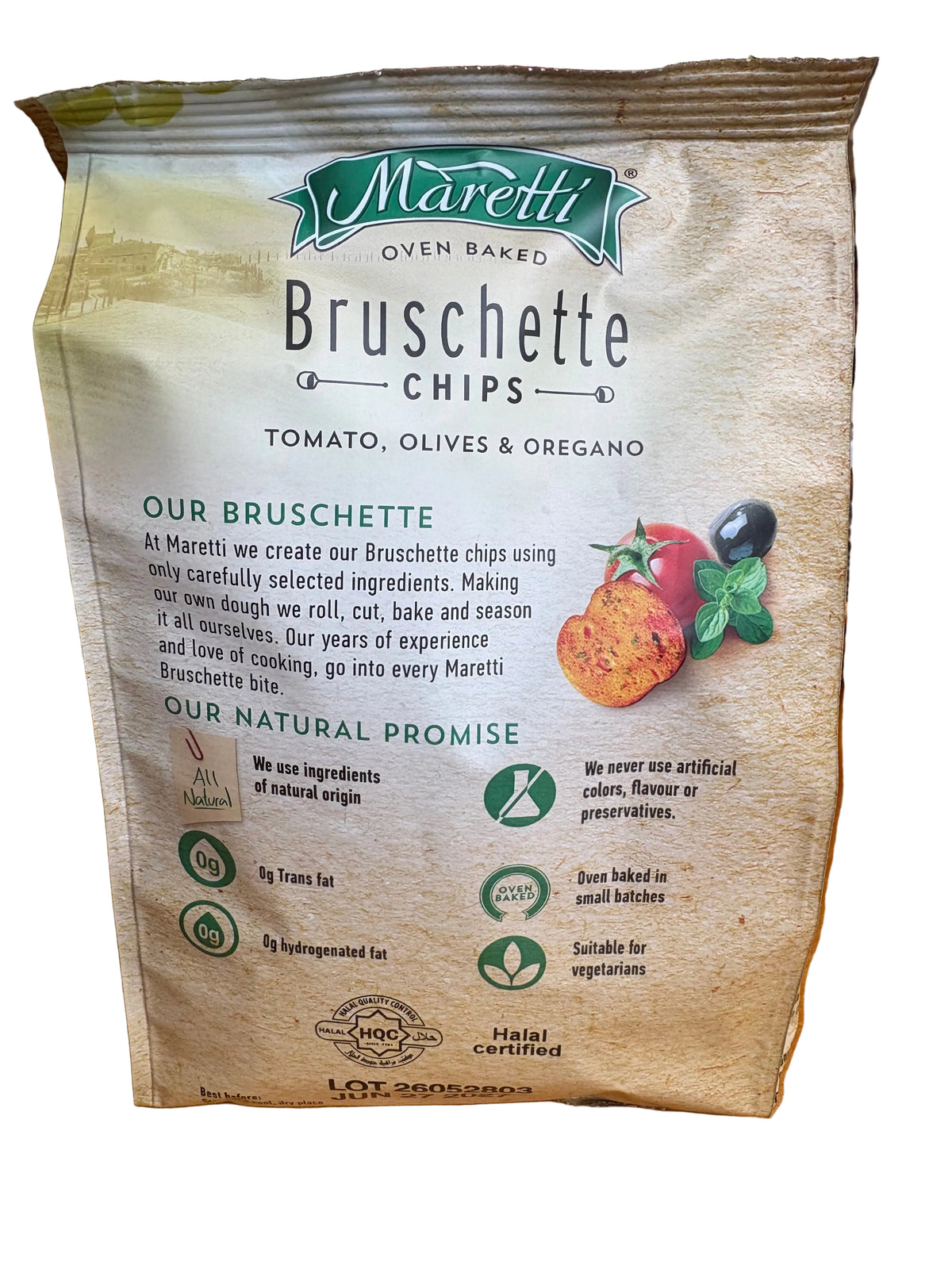 A bag of Maretti Bruschette Chips (Tomato, Olives & Oregano) placed on a wooden table with a blurred store background.